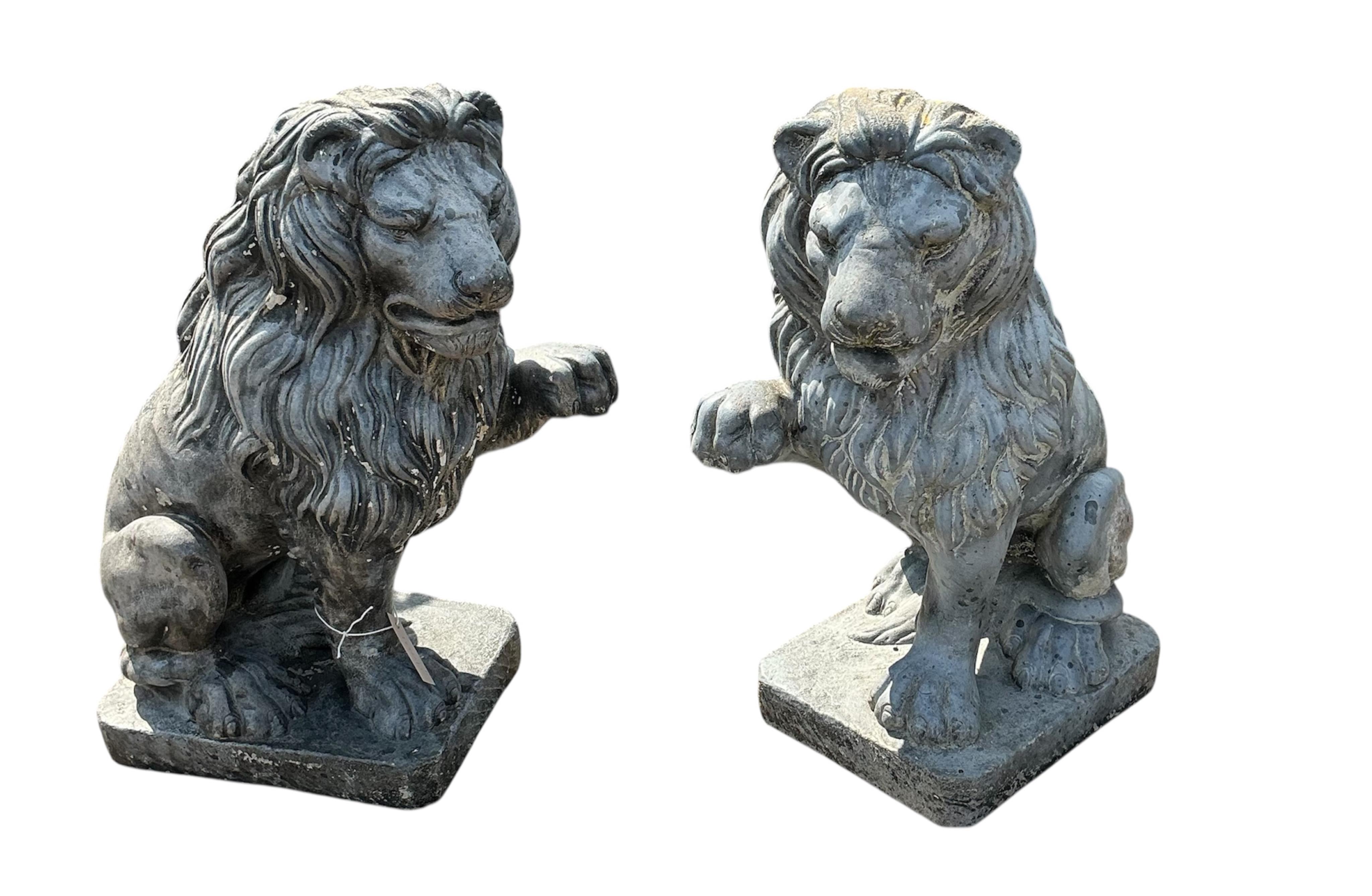 A pair of reconstituted stone, faux lead, lion passant garden ornaments, height 60cm